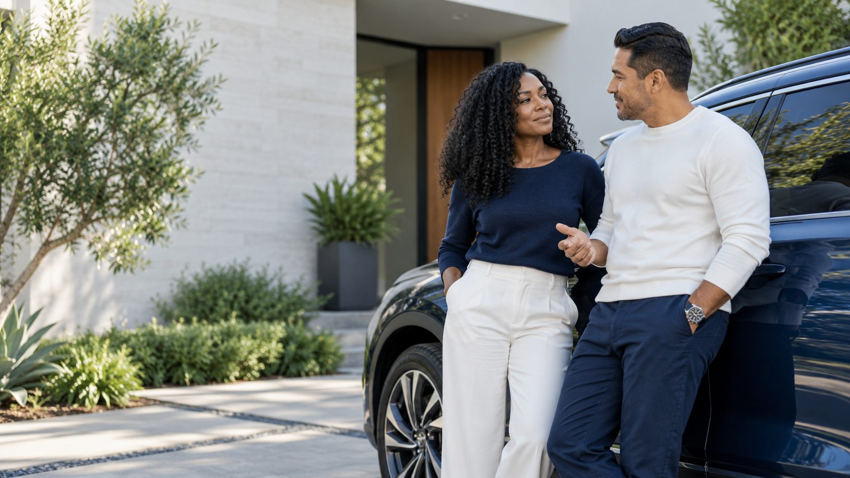 Couple discussing vehicle plans beside a blue SUV